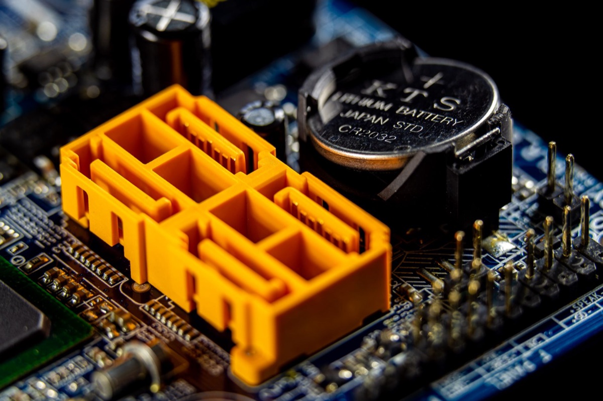 Extreme close-up of a computer circuit board with copper traces and microchips.