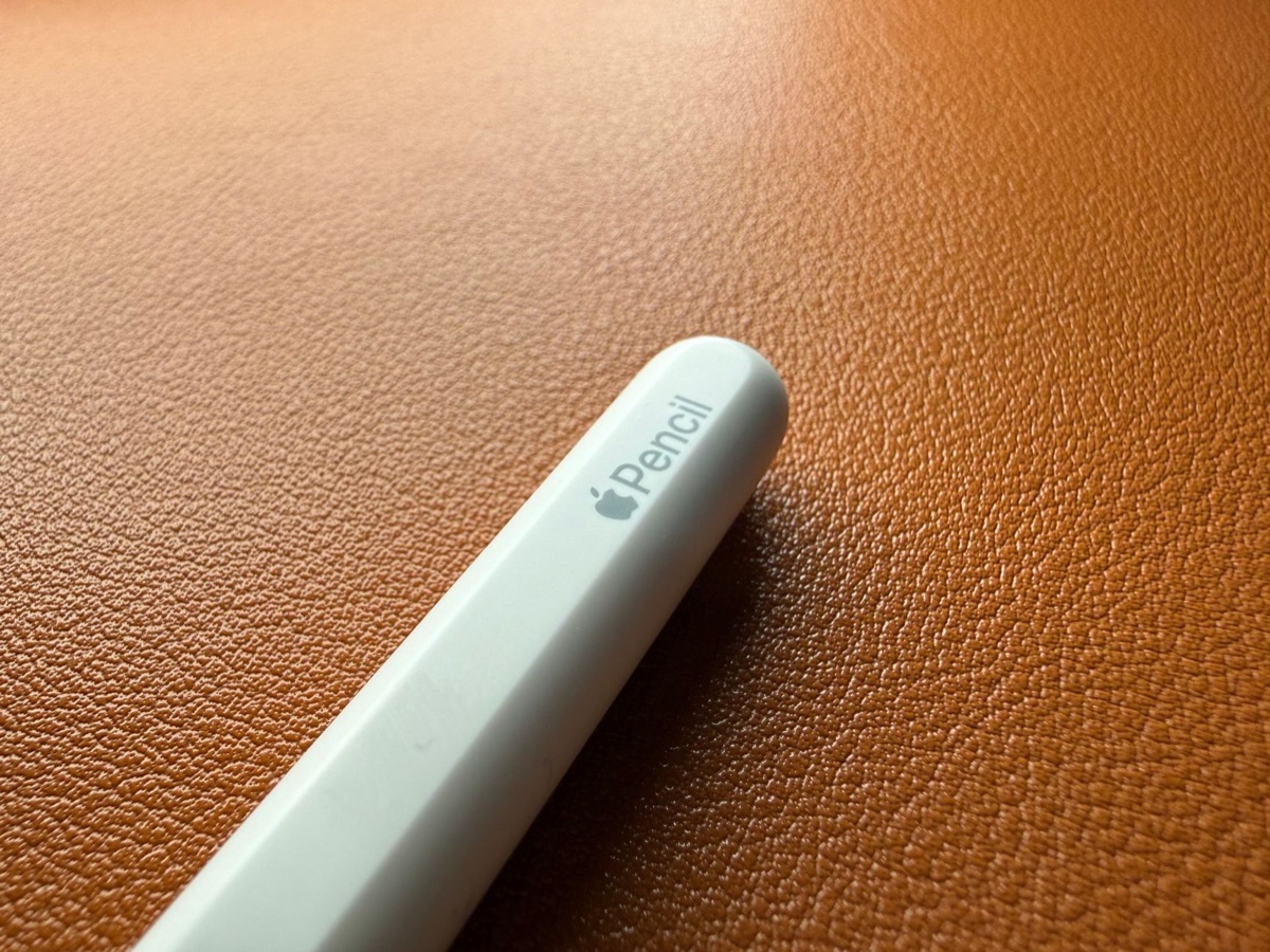 Stylus pen on white surface with digital design workspace